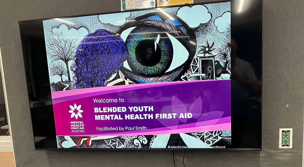 Television displaying "Welcome to 'BLENDED YOUTH MENTAL HEALTH FIRST AID'"